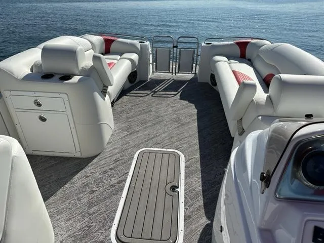 Slide: The Image of 2023 JC SportToon 24 TT pontoon boat interior with white and red seating. - 16