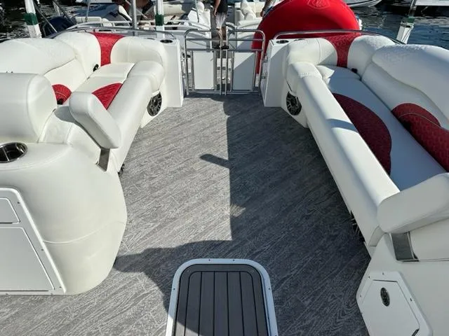 Slide: The Image of 2023 JC SportToon 24 TT pontoon boat interior with white and red seating. - 20