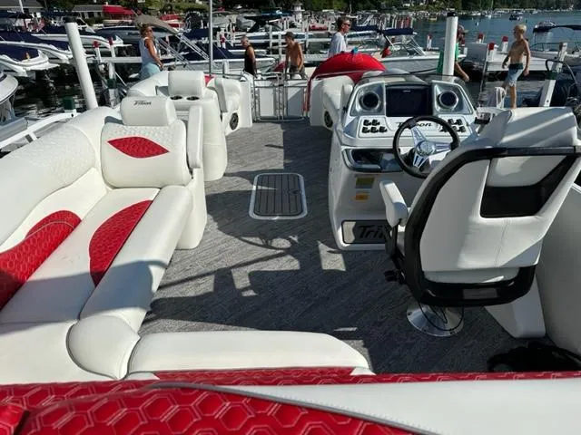 Slide: The Image of Interior of 2023 JC SportToon 24 TT pontoon boat with white and red seating. - 24