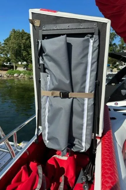 Slide: The Image of 2023 JC SportToon 24 TT boat storage compartment with gray and red accessories. - 26