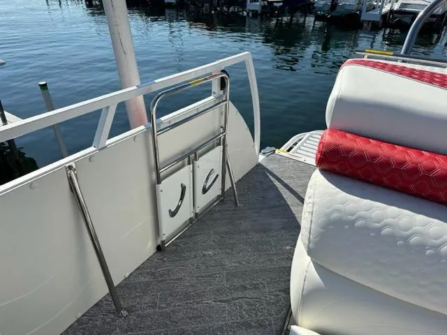 Slide: The Image of 2023 JC SportToon 24 TT pontoon boat with rear seating and water access ladder. - 27