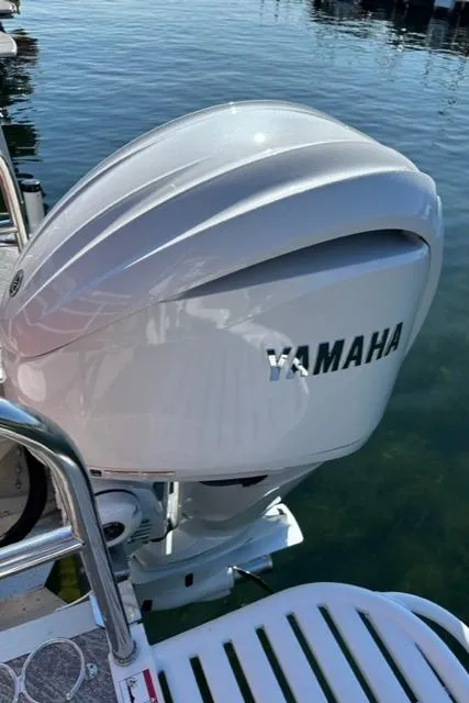 Slide: The Image of 2023 JC SportToon 24 TT with Yamaha outboard motor on water. - 32