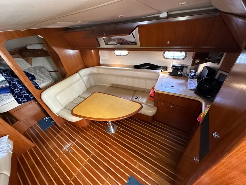 Slide: The Image of 2004 Tiara Yachts 3600 Sovran interior with wood flooring and L-shaped seating. - 19