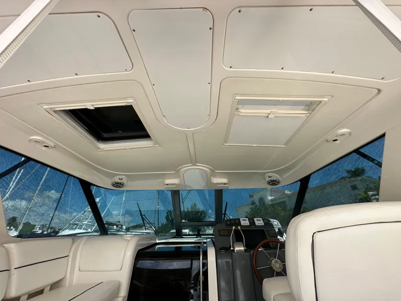 Slide: The Image of Interior view of 2004 Tiara Yachts 3600 Sovran, showing helm and seating area. - 22