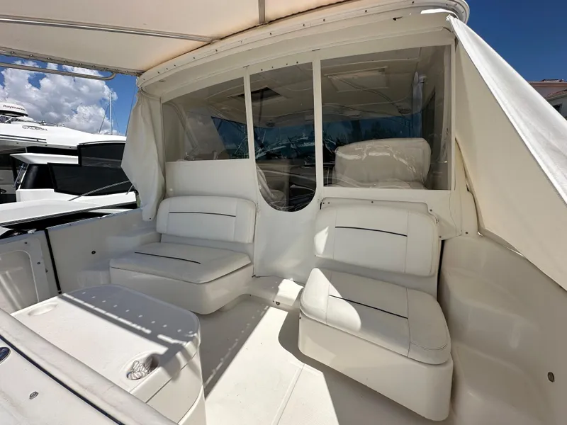 Slide: The Image of 2004 Tiara Yachts 3600 Sovran cockpit with white seating and canopy. - 6