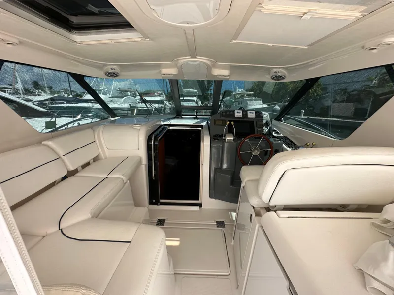 Slide: The Image of 2004 Tiara Yachts 3600 Sovran interior with white seating and helm station. - 7