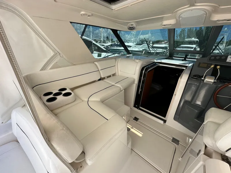 Slide: The Image of Interior of a 2004 Tiara Yachts 3600 Sovran with white seating and helm station. - 8