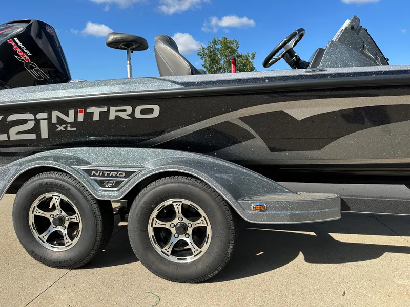Slide: The Image of 2024 Nitro Z21 XL Pro boat on a trailer with dual wheels. - 2