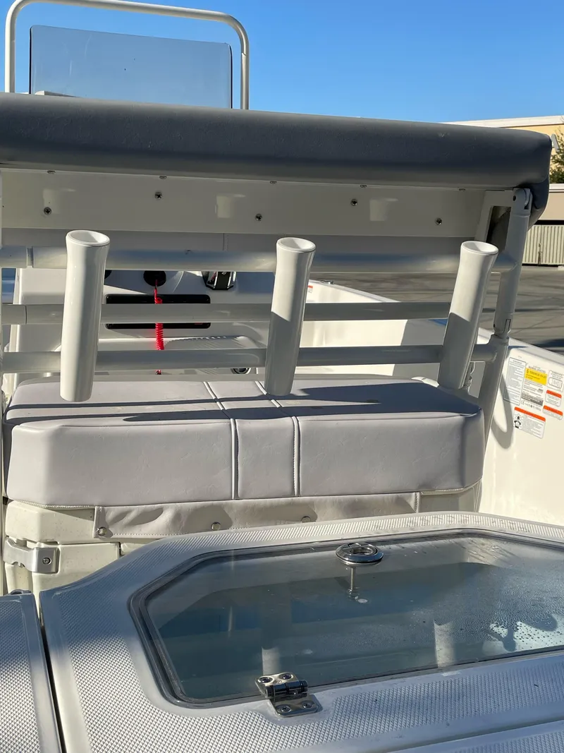 Slide: The Image of 2023 Mako Pro Skiff 19 CC boat interior with rod holders and seating. - 3