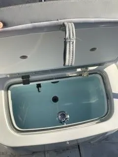 Slide: The Image of Open storage compartment on 2023 Mako Pro Skiff 19 CC boat. - 7