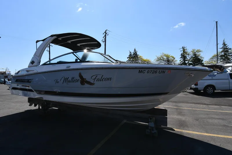 The Image of 2021 Monterey 278 Super Sport boat named The Maltese Falcon on a trailer in a parking lot. - 0