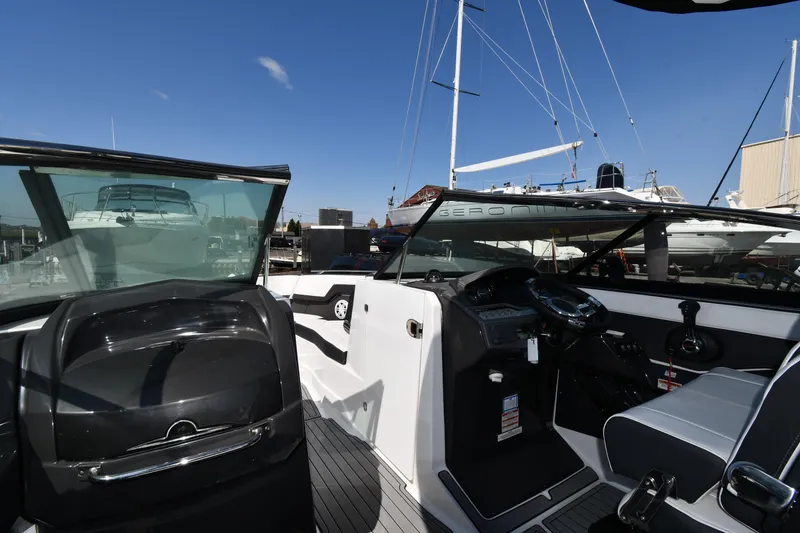 Slide: The Image of 2021 Monterey 278 Super Sport boat interior with steering console and seating. - 13