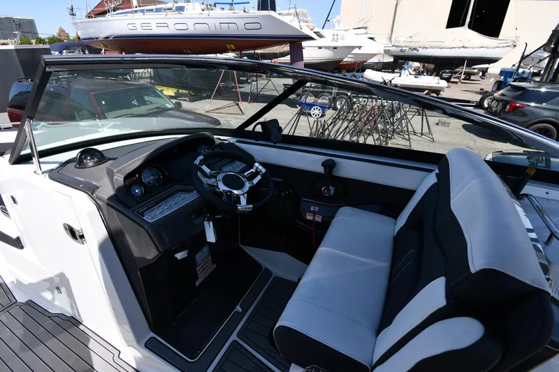 Slide: The Image of 2021 Monterey 278 Super Sport boat interior with steering wheel and seating. - 14