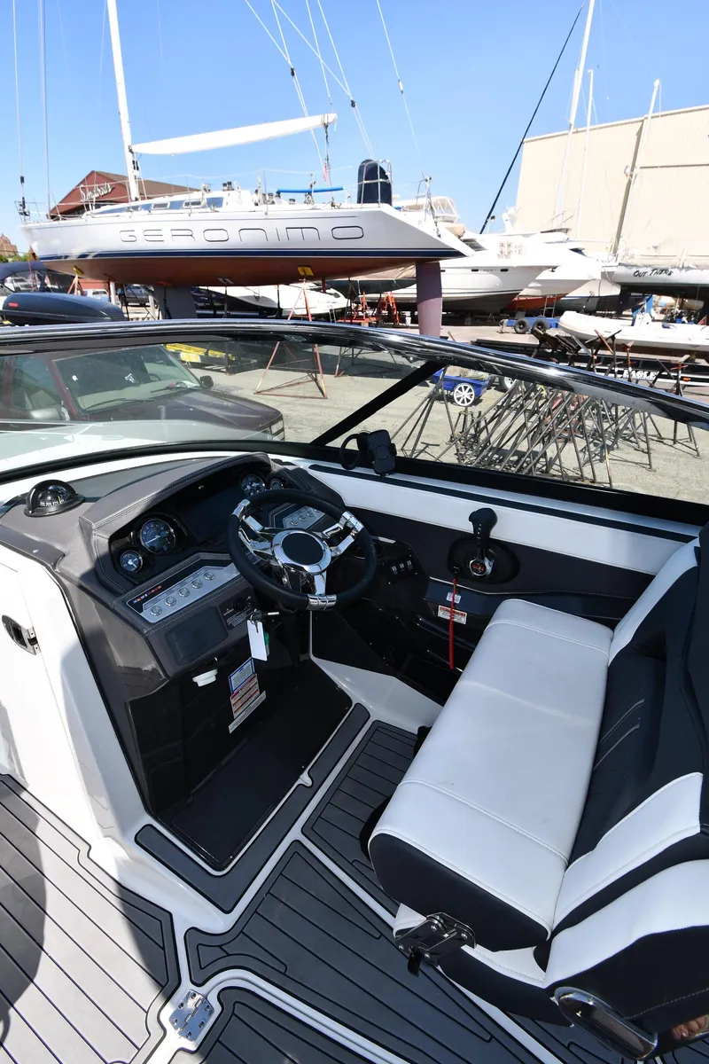 Slide: The Image of 2021 Monterey 278 Super Sport boat interior with steering wheel and seating. - 15