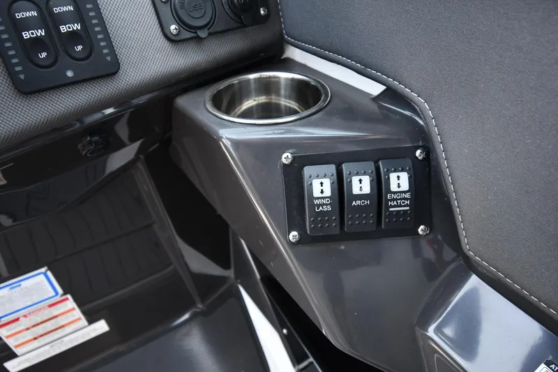 Slide: The Image of 2021 Monterey 278 Super Sport boat control panel with cup holder and switches. - 18