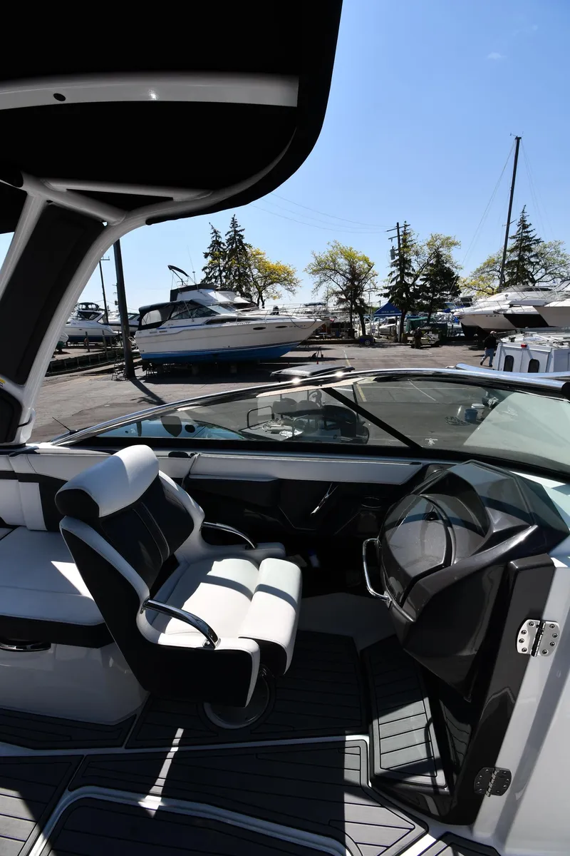 Slide: The Image of 2021 Monterey 278 Super Sport boat interior with captain's chair and steering wheel. - 23