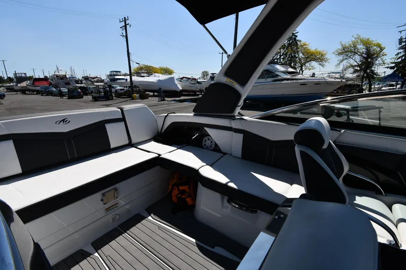 Slide: The Image of 2021 Monterey 278 Super Sport boat interior with seating and storage at a marina. - 24