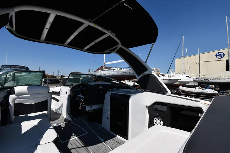 Slide: The Image of 2021 Monterey 278 Super Sport boat interior at marina with other boats. - 28