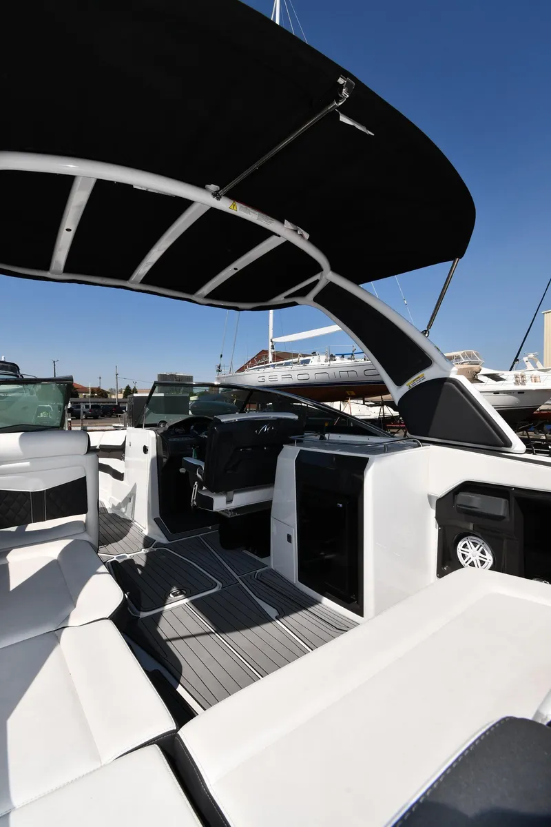 Slide: The Image of 2021 Monterey 278 Super Sport boat interior with black canopy and white seating. - 29