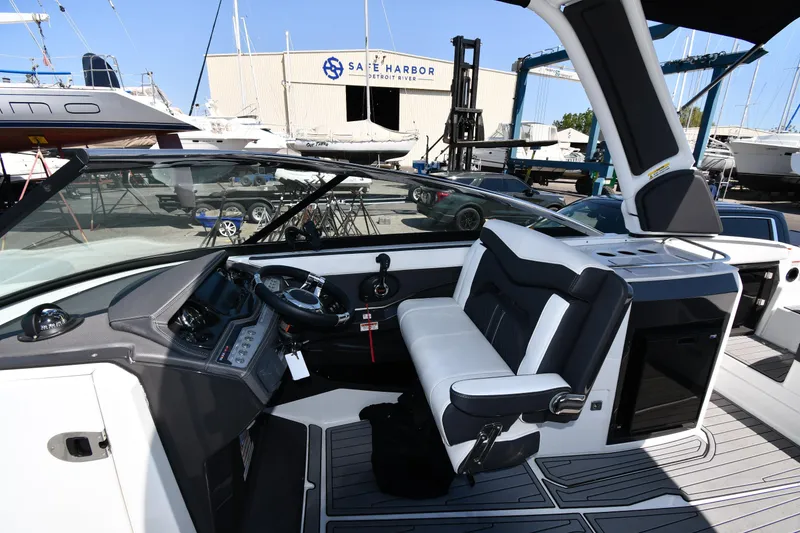 Slide: The Image of 2021 Monterey 278 Super Sport boat cockpit with steering wheel and captain's chair. - 20