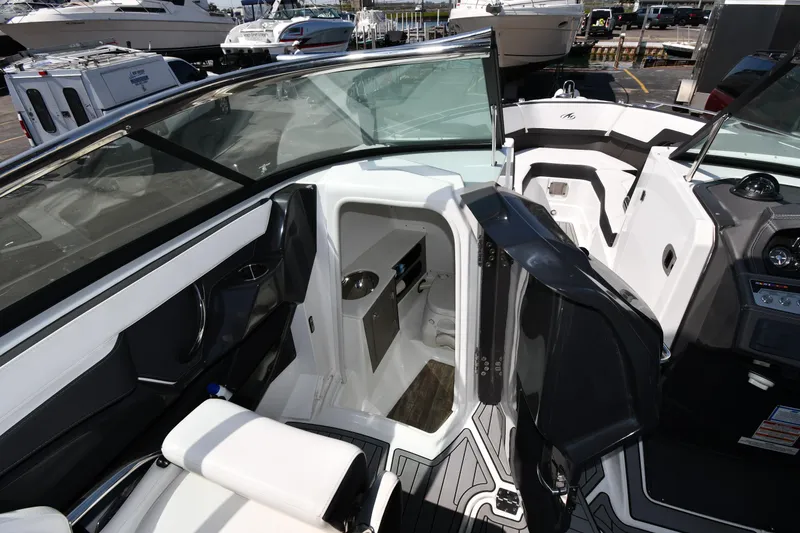 Slide: The Image of 2021 Monterey 278 Super Sport boat interior with open cabin door and seating. - 41