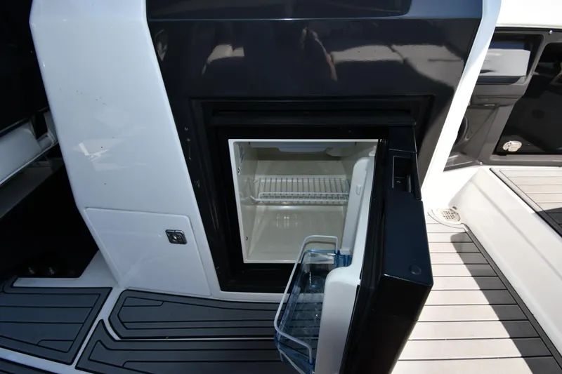 Slide: The Image of 2021 Monterey 278 Super Sport boat with open mini fridge on deck. - 33