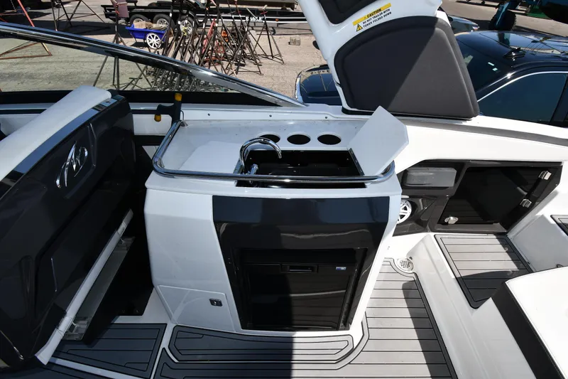 Slide: The Image of 2021 Monterey 278 Super Sport boat interior with kitchenette and seating area. - 32