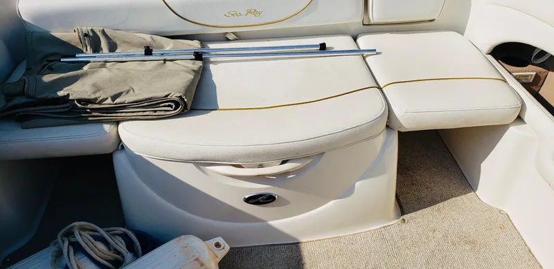 Slide: The Image of 2001 Sea Ray 225 Weekender boat interior with seating, folded tarp, and boating accessories. - 5