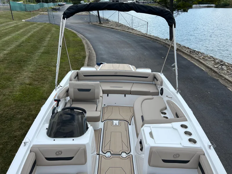 Slide: The Image of 2024 Hurricane SunDeck Sport 205 IO boat interior with seating and bimini top. - 14