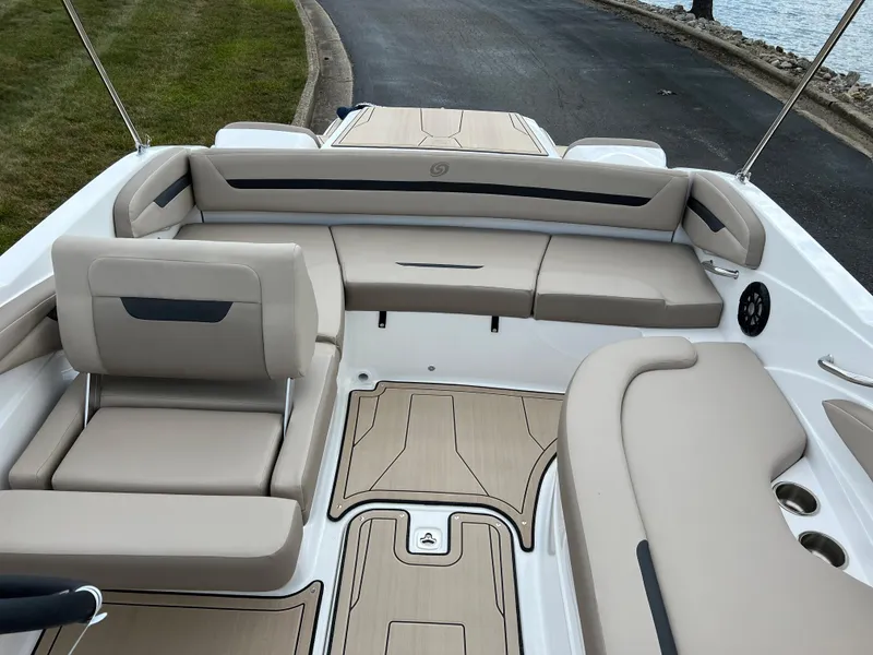Slide: The Image of 2024 Hurricane SunDeck Sport 205 IO boat interior with beige seating and wood accents. - 18
