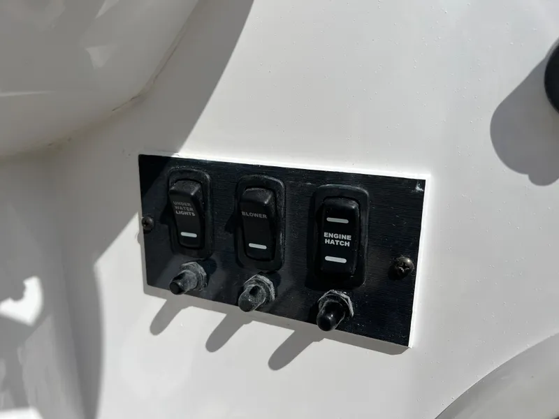 Slide: The Image of Control panel switches on 2024 Hurricane SunDeck Sport 205 IO boat. - 23