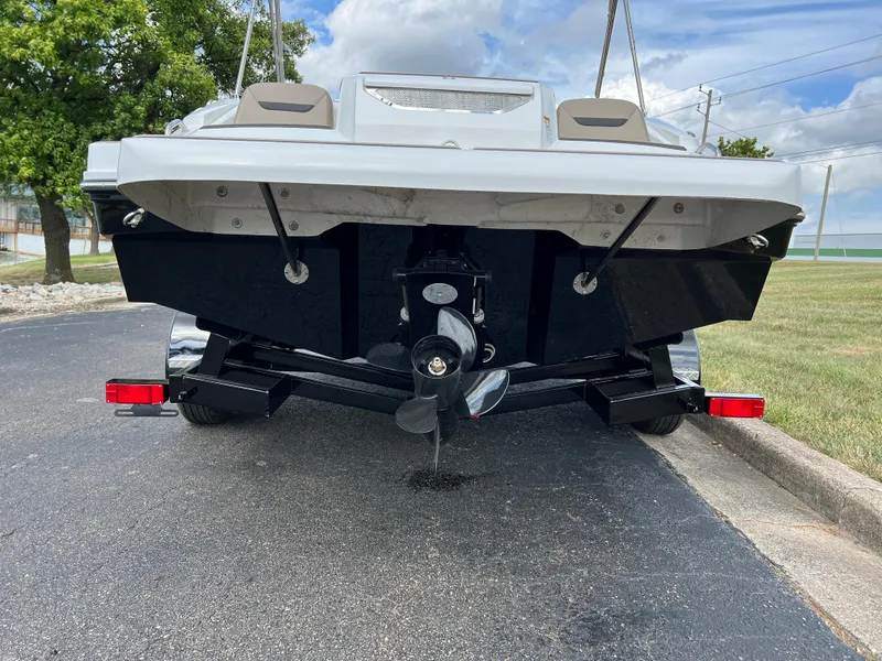 Slide: The Image of 2024 Hurricane SunDeck Sport 205 IO boat rear view with propeller and trailer. - 5