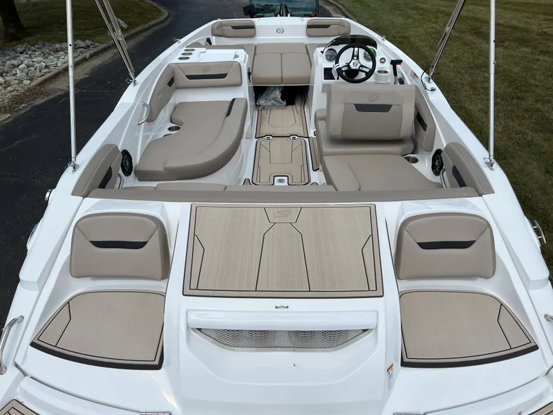 Slide: The Image of 2024 Hurricane SunDeck Sport 205 IO boat interior with beige seating and modern design. - 7
