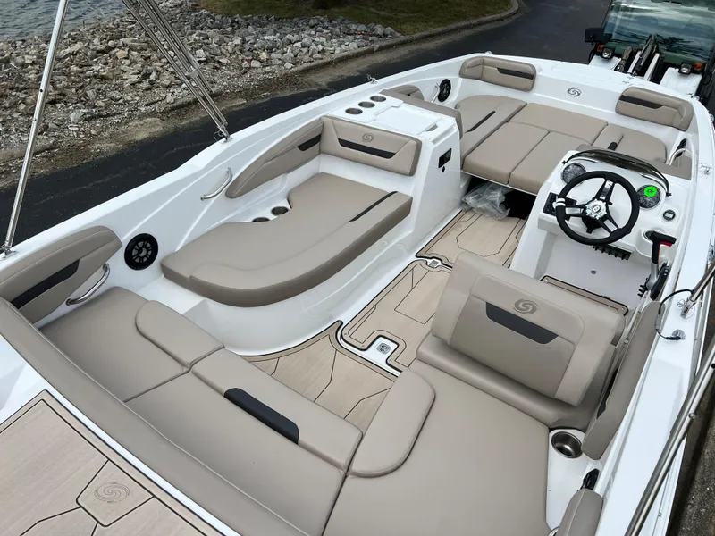Slide: The Image of 2024 Hurricane SunDeck Sport 205 IO boat interior with beige seating and modern dashboard. - 8