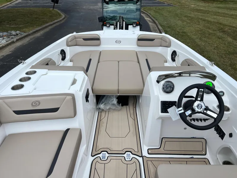 Slide: The Image of 2024 Hurricane SunDeck Sport 205 IO boat interior with beige seating and modern dashboard. - 9