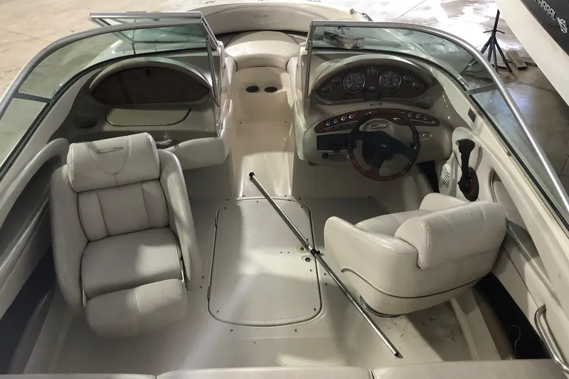 Slide: The Image of Interior of a 2002 Maxum 1900 SR boat with white seating and dashboard. - 13
