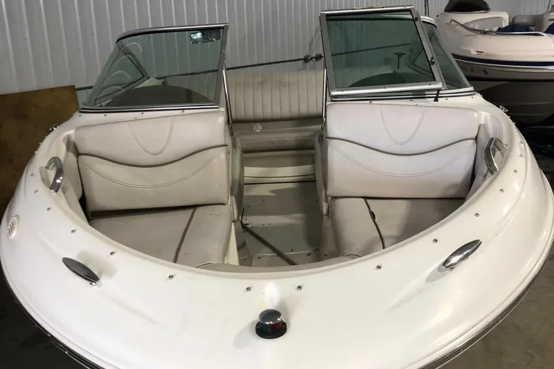 Slide: The Image of 2002 Maxum 1900 SR boat interior with white seating and windshield. - 14