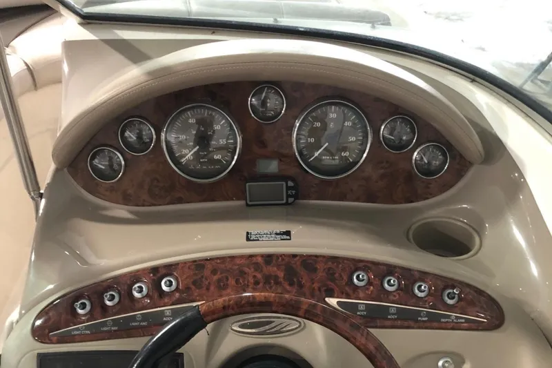 Slide: The Image of 2002 Maxum 1900 SR boat dashboard with gauges and controls. - 8