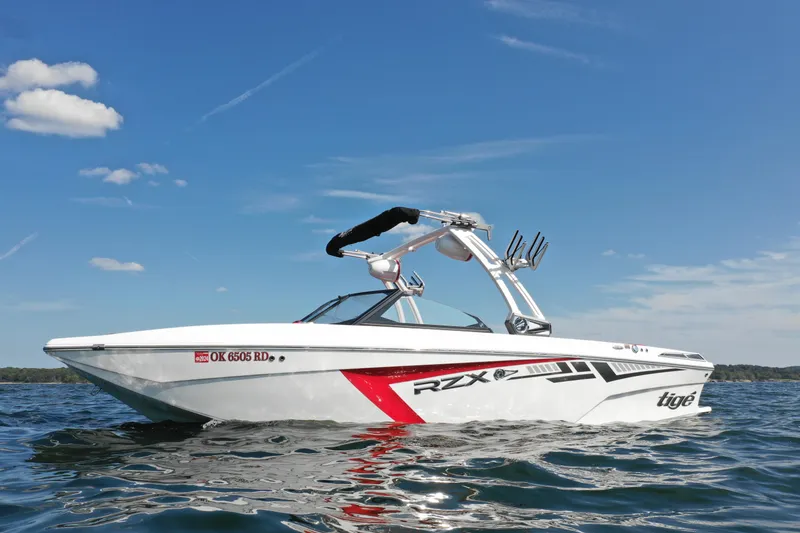 Slide: The Image of 2021 Tigé 22RZX boat on a sunny day on the water. - 1