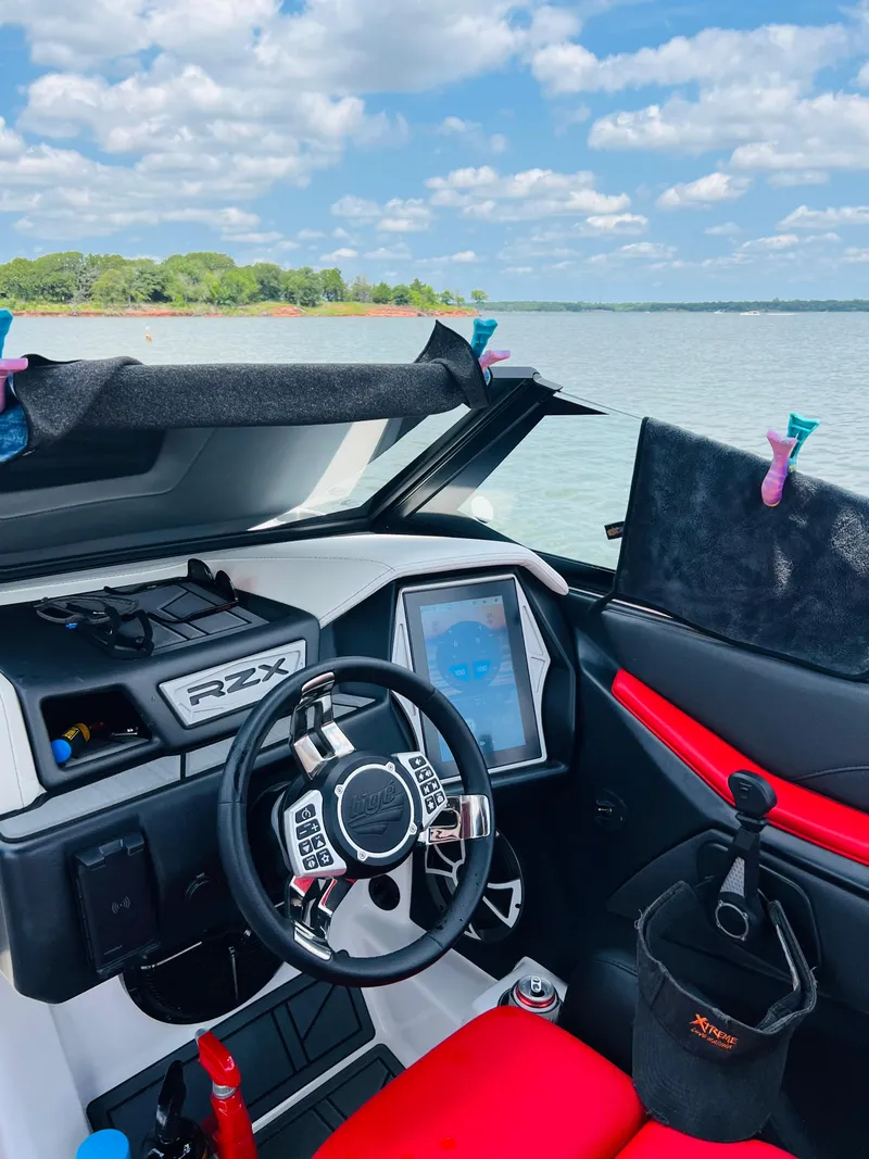 Slide: The Image of 2021 Tigé 22RZX boat interior with steering wheel and touchscreen display. - 13