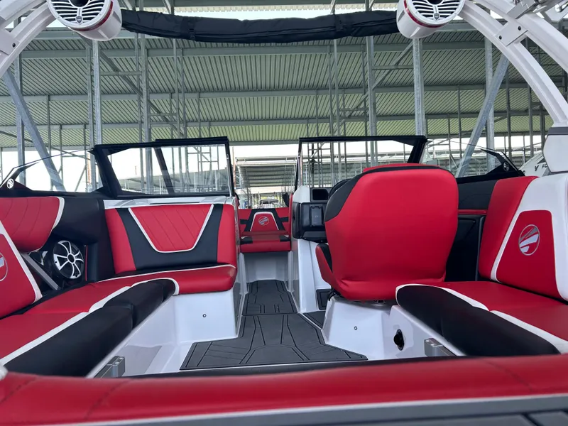 Slide: The Image of 2021 Tigé 22RZX boat interior with red and black seating. - 14