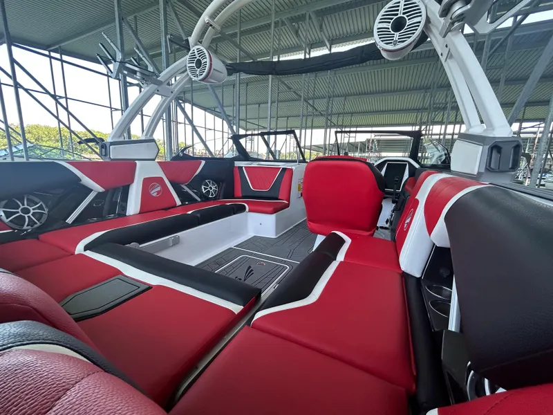 Slide: The Image of 2021 Tigé 22RZX boat interior with red and black seating, advanced sound system. - 15
