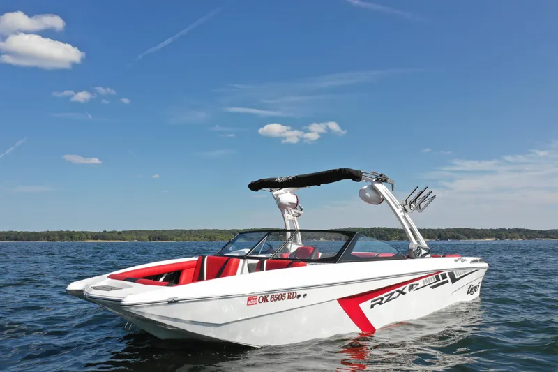 Slide: The Image of 2021 Tigé 22RZX boat on a lake under a clear blue sky. - 2