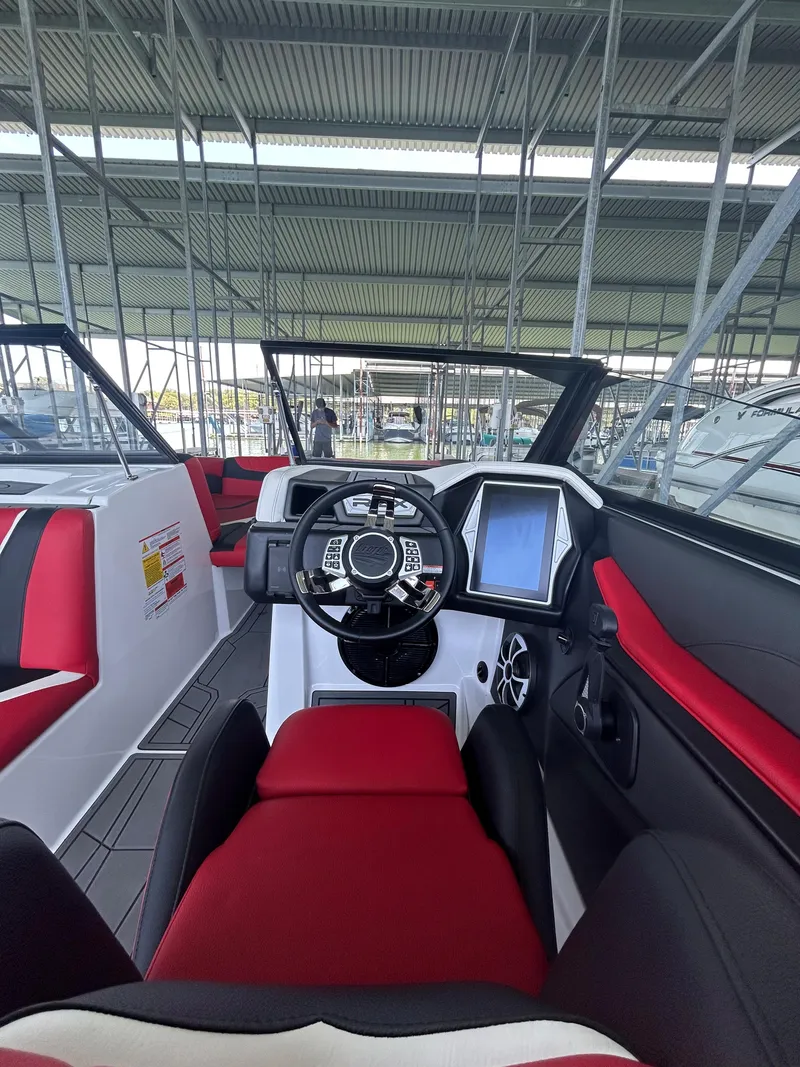 Slide: The Image of 2021 Tigé 22RZX boat interior with modern dashboard and red-black seating. - 20
