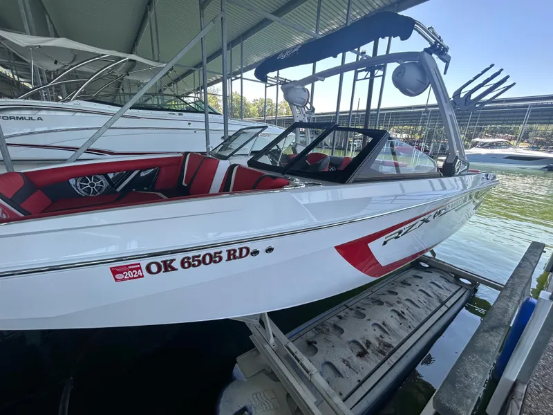 Slide: The Image of 2021 Tigé 22RZX boat docked, white with red interior, registration OK 6505 RD. - 21