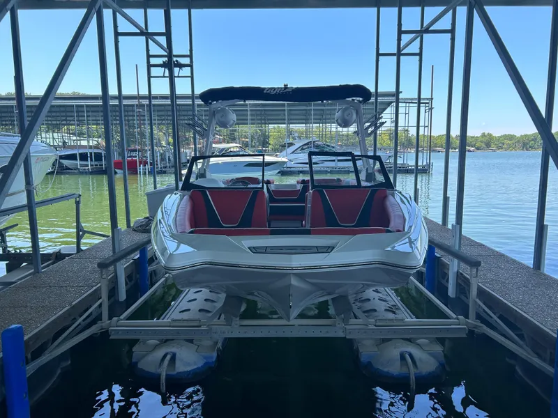 Slide: The Image of 2021 Tigé 22RZX boat docked at a marina. - 23