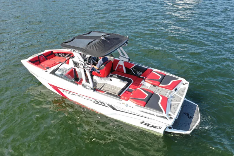 Slide: The Image of 2021 Tigé 22RZX boat on water, red and white design, black canopy. - 4