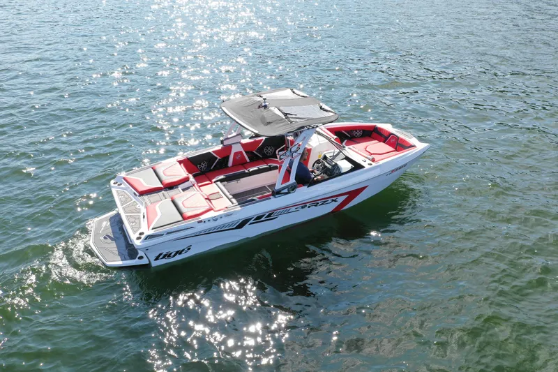 Slide: The Image of 2021 Tigé 22RZX boat on water, red and white design, top view. - 5