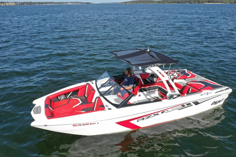 Slide: The Image of 2021 Tigé 22RZX boat on open water with red and white interior. - 7