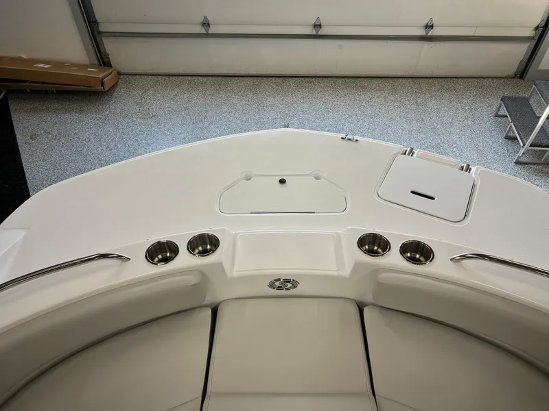Slide: The Image of 2024 Hurricane SunDeck 187 IO boat interior with cup holders and storage compartments. - 11